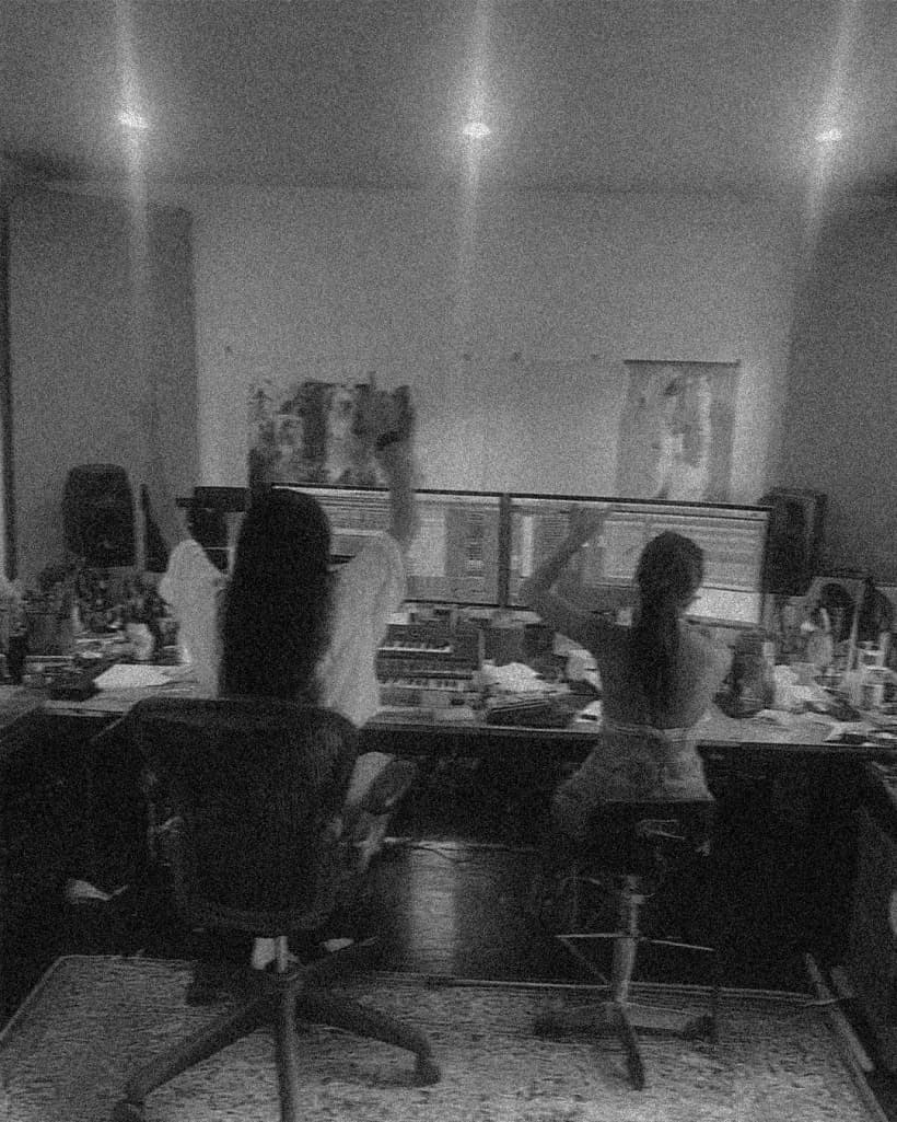 Two collaborators working together in a recording studio
