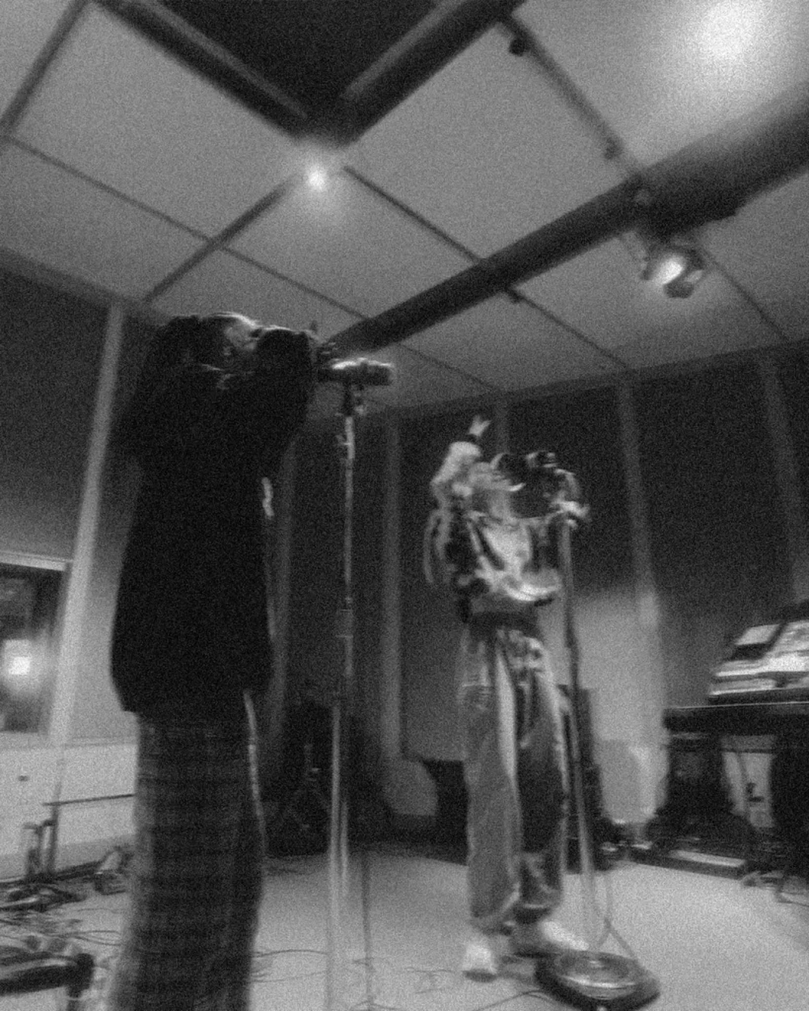A vocalist recording during a studio session